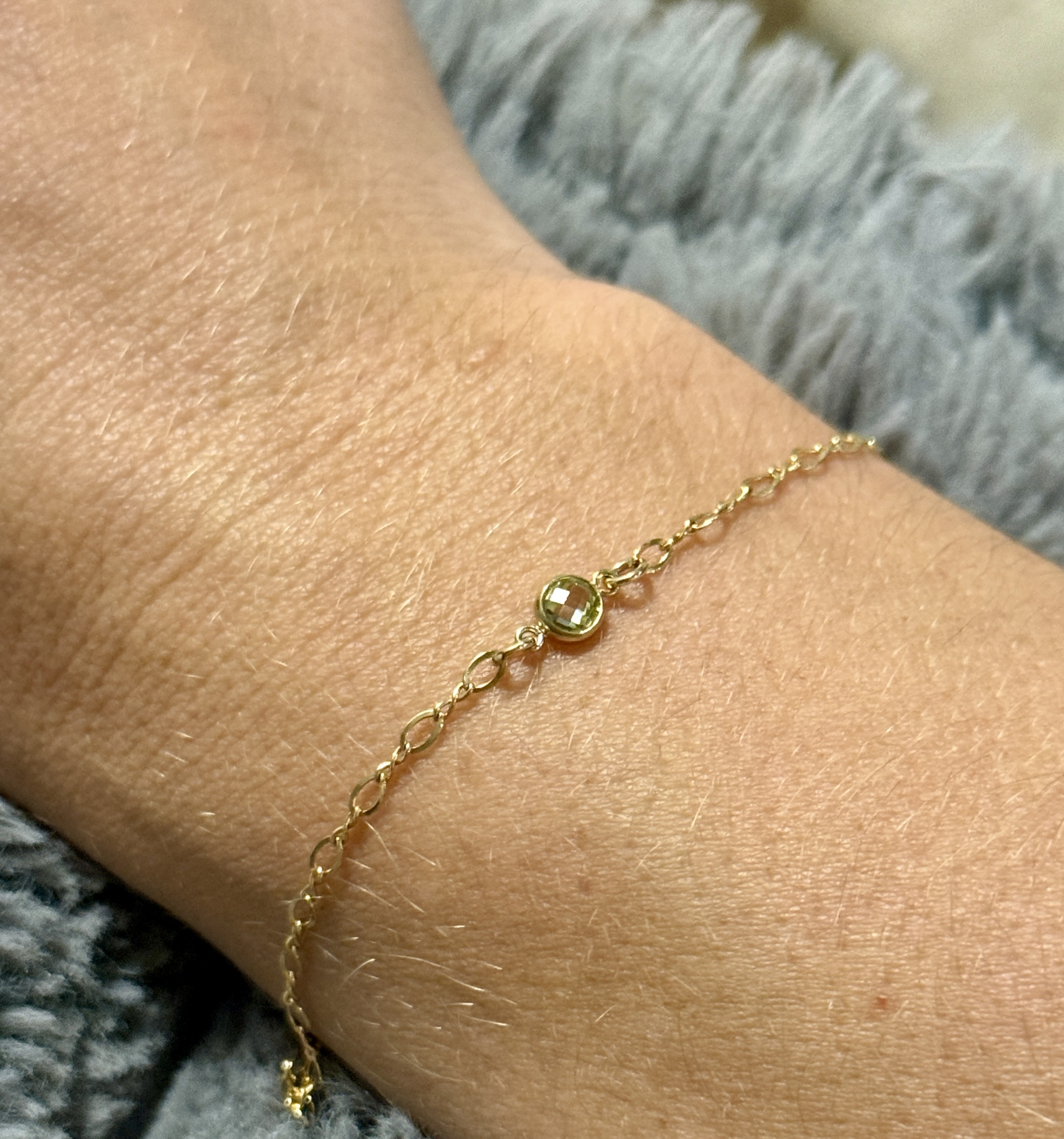 Peridot gemstone bracelet worn on the wrist